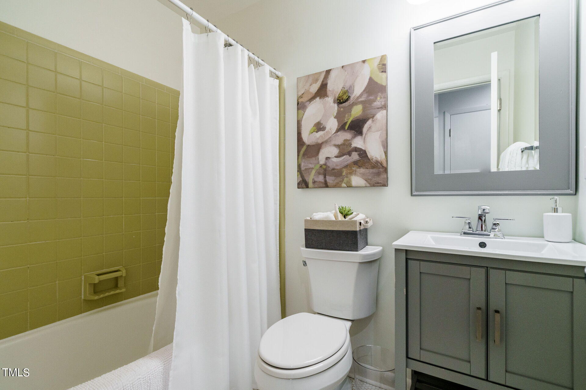 318 Glen Valley Road Raleigh, NC 27609 - Photo 31 of 39 a bathroom with a toilet sink and mirror