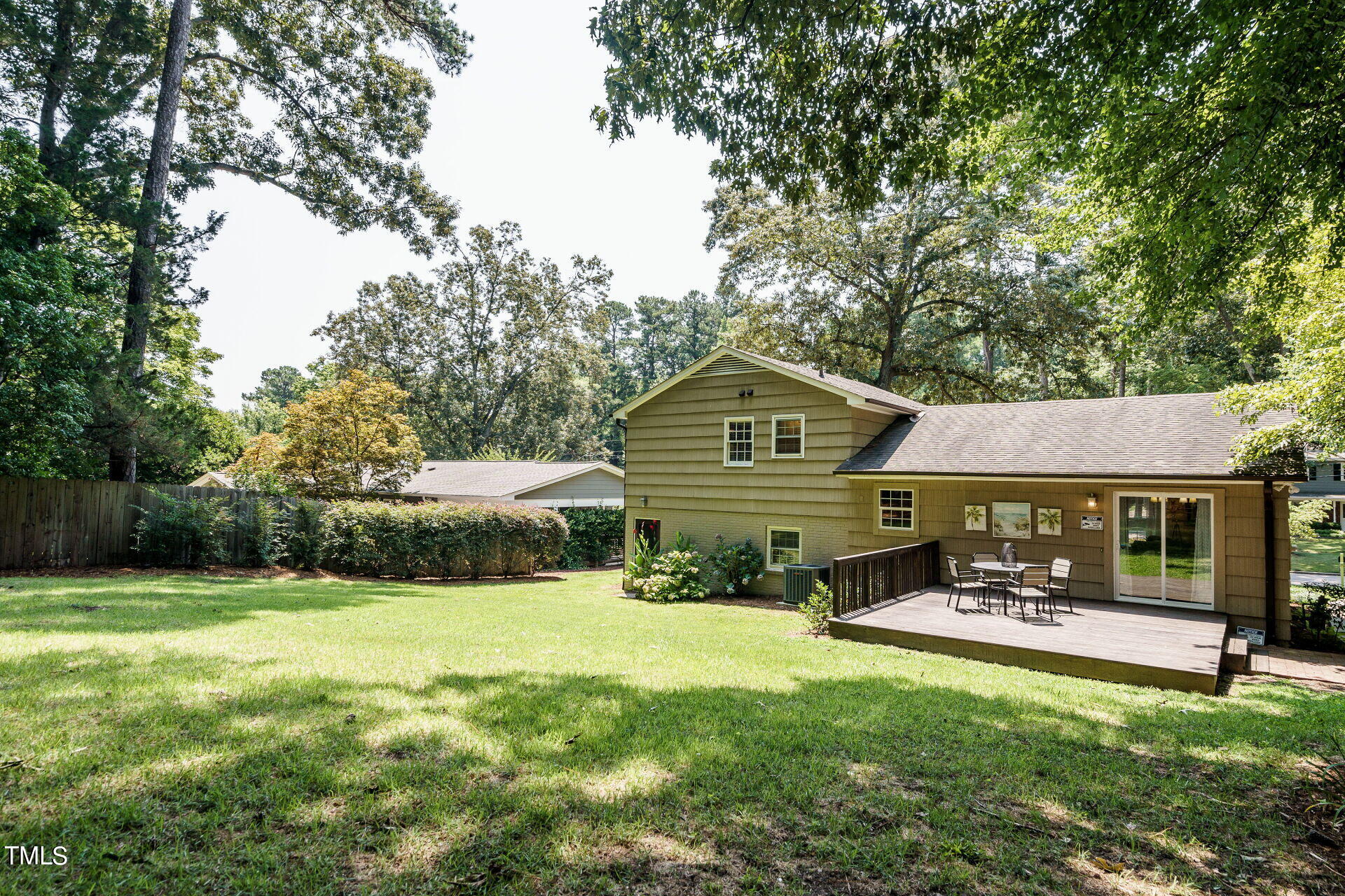 318 Glen Valley Road Raleigh, NC 27609 - Photo 36 of 39 a view of a patio with table and chairs under an umbrella