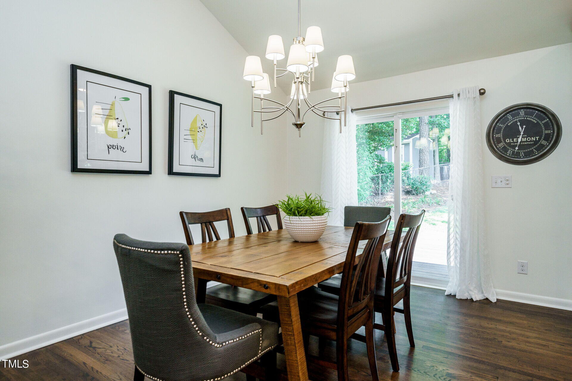 318 Glen Valley Road Raleigh, NC 27609 - Photo 6 of 39 a view of a dining room with furniture a chandelier and wooden floor