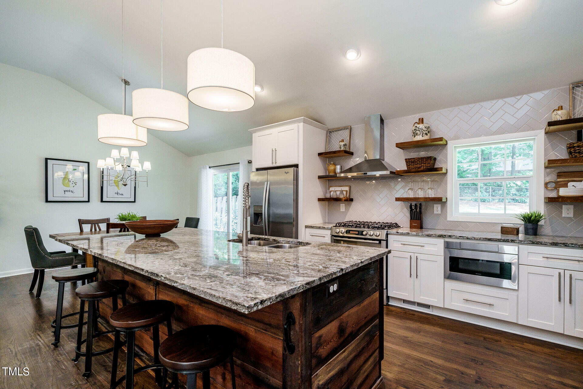 318 Glen Valley Road Raleigh, NC 27609 - Photo 10 of 39 a kitchen with a stove a table and chairs in it