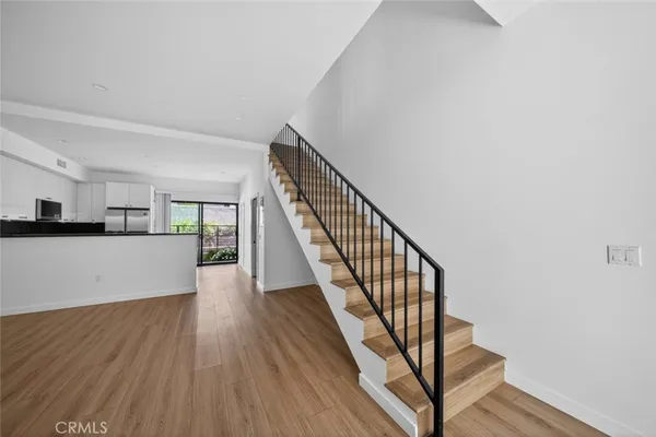 a view of entryway and hall with wooden floor