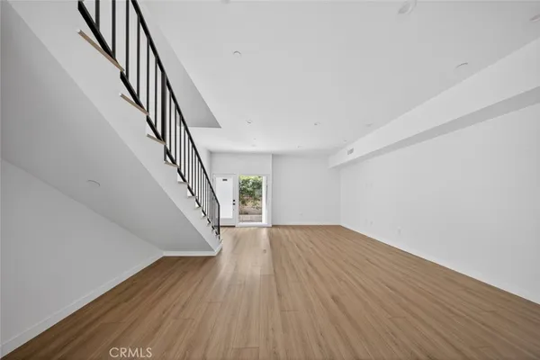 a view of an entryway with wooden floor