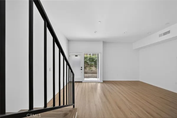 a large kitchen with stainless steel appliances granite countertop a stove a sink and a refrigerator