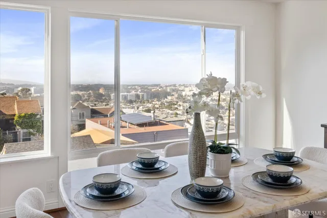 a kitchen with stainless steel appliances granite countertop a sink a stove a refrigerator a microwave oven with white cabinets and granite countertops