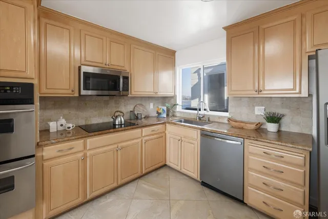 a bedroom with a bed painting on wall and a potted plant