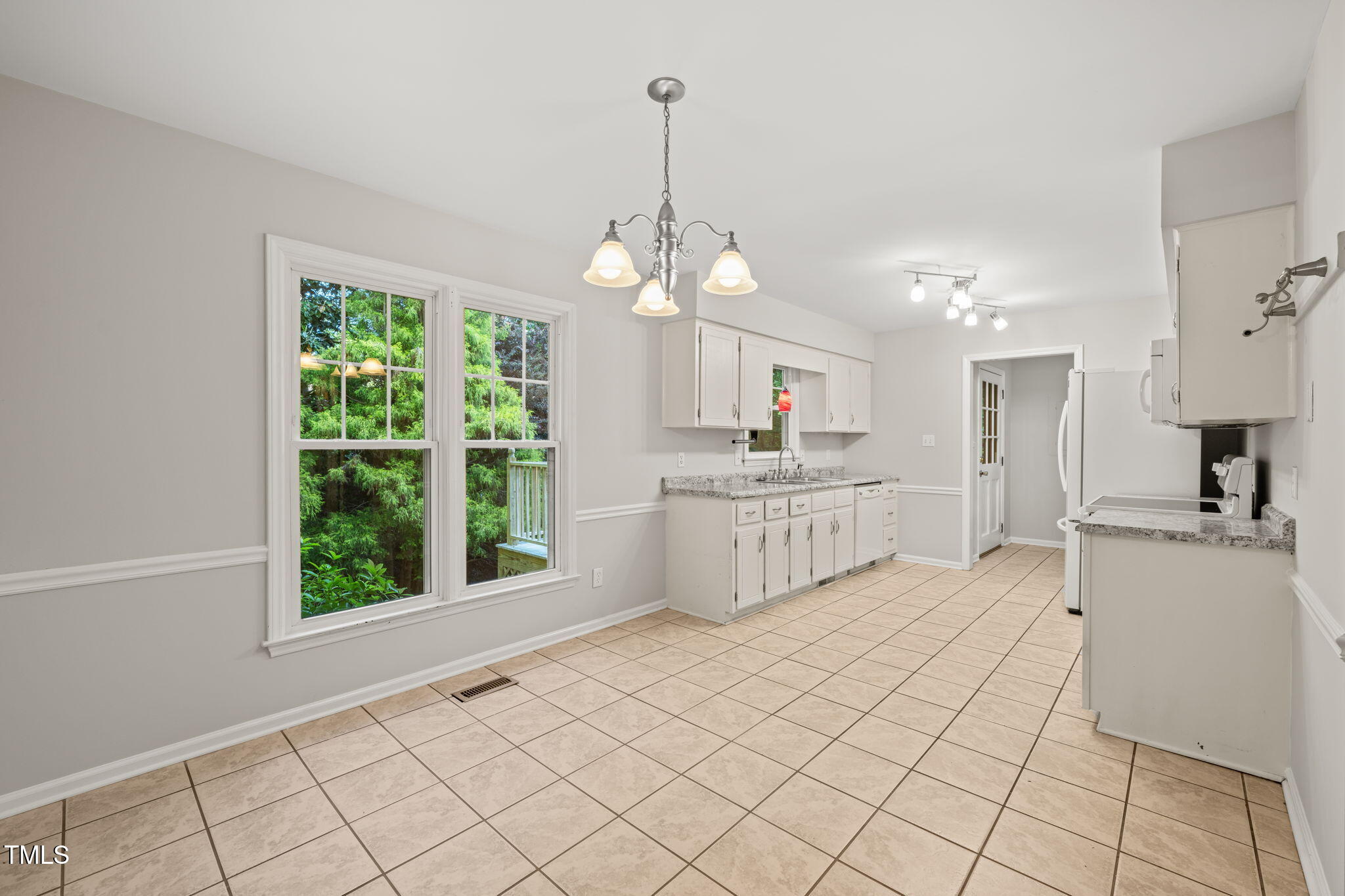 5212 Badham Place Raleigh, NC 27609 - Photo 20 of 40 a large white kitchen with a window and kitchen view
