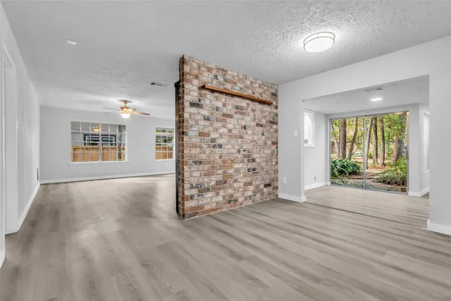 a view of a livingroom with wooden floor and a window