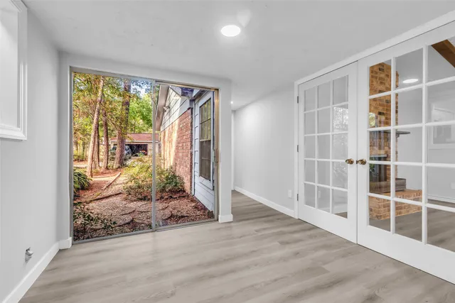 a view of empty room with wooden floor