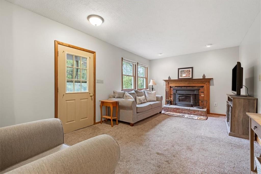 207 Amsler Road Sewickley, PA 15143 - Photo 5 of 33 a living room with furniture a flat screen tv and a fireplace