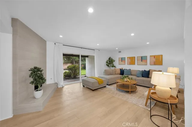 a living room with furniture potted plant and a window