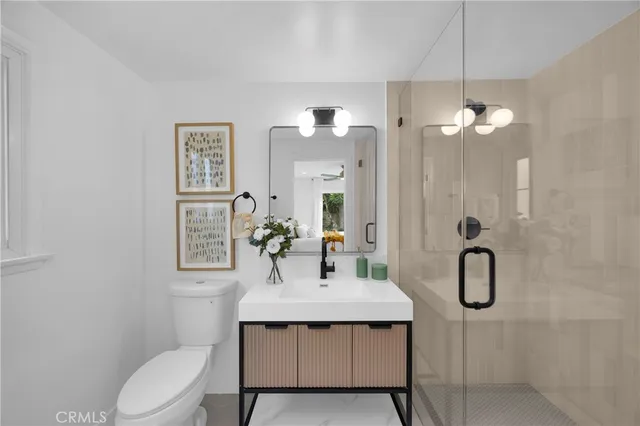 a bathroom with a toilet sink shower and mirror