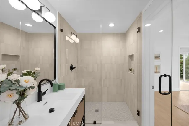 a bathroom with a tub sink and mirror