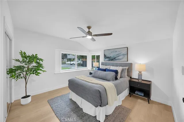 a bedroom with a bed and a potted plant