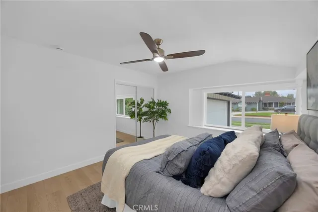 a bedroom with a large bed and a large window