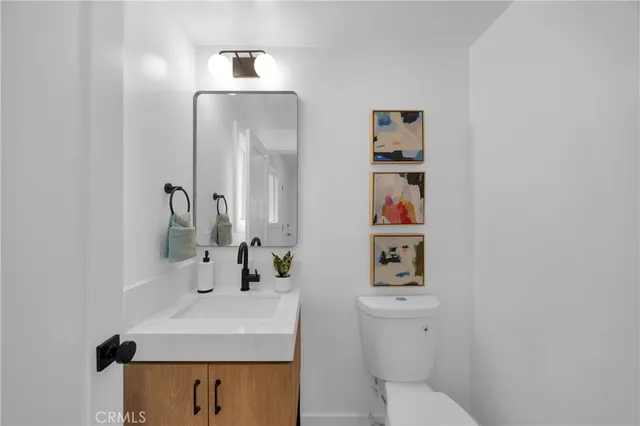a bathroom with a sink a toilet and mirror