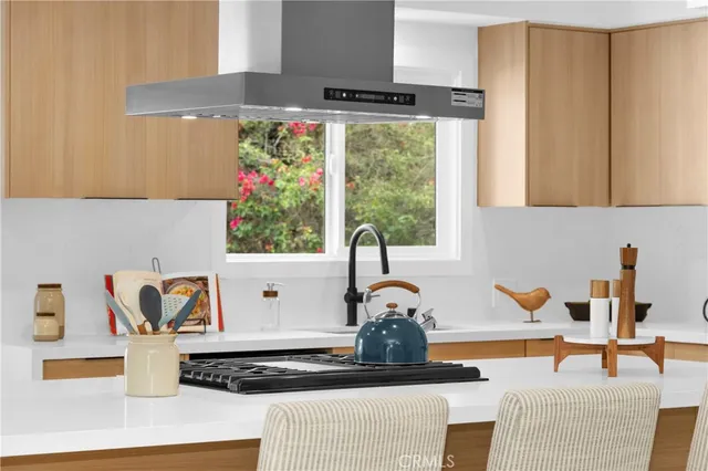 a kitchen with a sink and a stove top oven