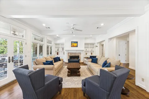 a living room with fireplace furniture and a large window