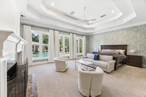 a living room with furniture a fireplace and a chandelier
