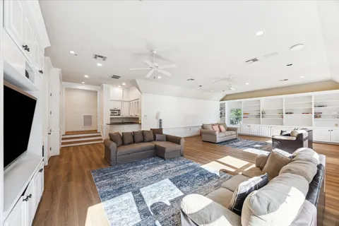 a living room with furniture fireplace and a large window