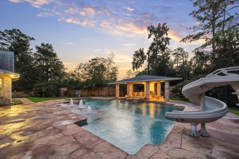 a backyard of a house with table and chairs