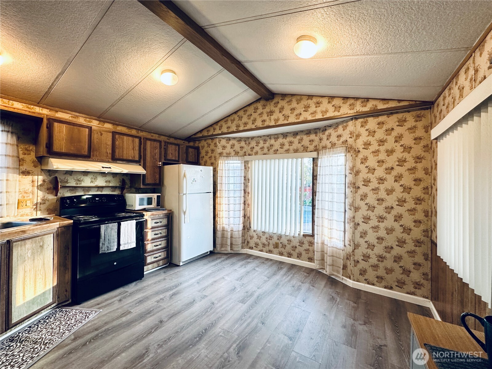 5600 Mt Solo Road, Unit 124 Longview, WA 98632 - Photo 5 of 21 a kitchen with stainless steel appliances granite countertop a refrigerator a sink dishwasher a stove and white countertops with wooden floor