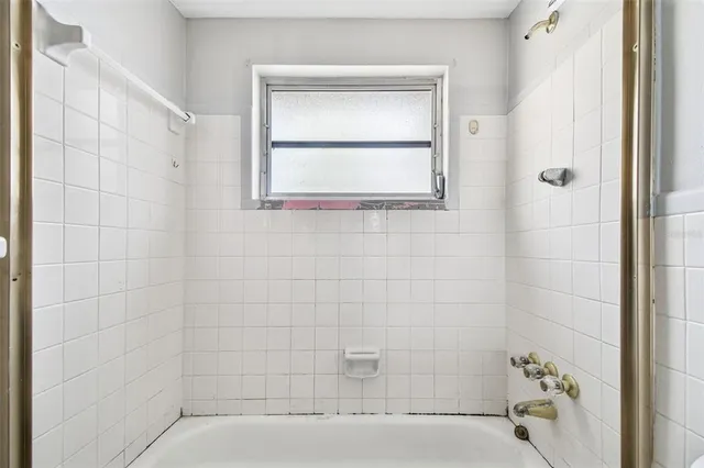 a room with wooden floor and windows