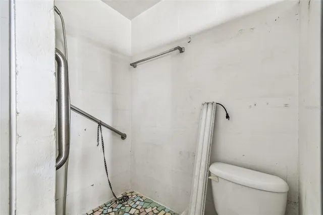 a view of a house with a swimming pool and sitting area