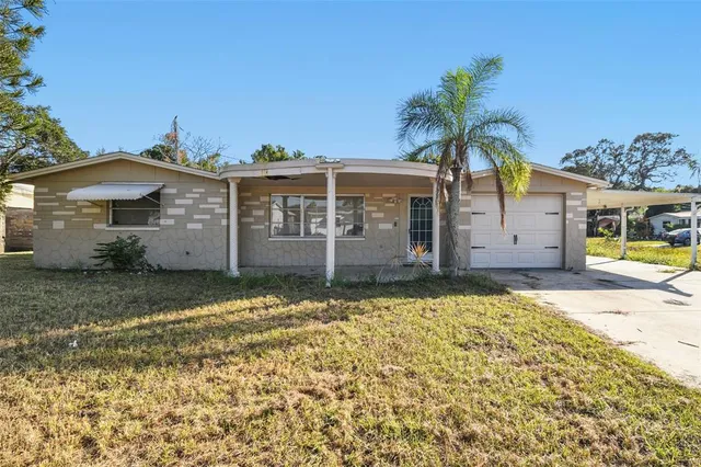 a view of a swimming pool with patio and wooden fence