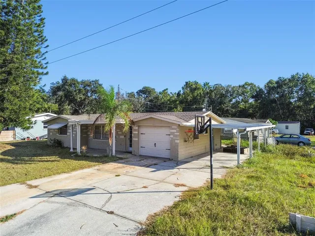 a view of a white house with a swimming pool