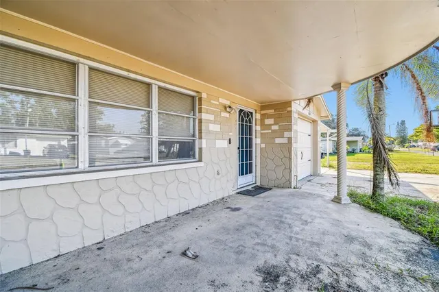 a kitchen with a refrigerator a stove and a sink with wooden floor