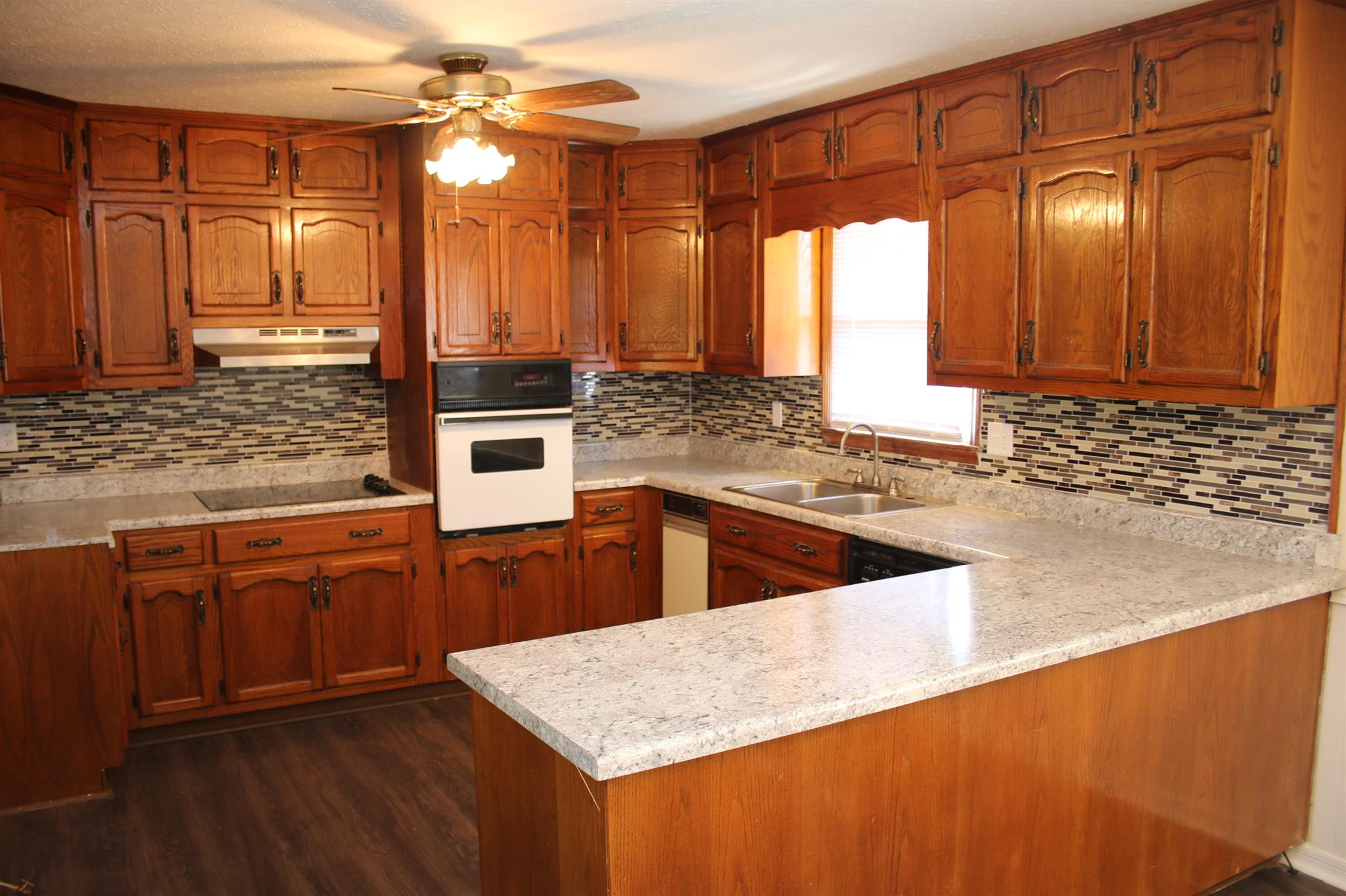 30377 Old Scrouge Road Ardmore, AL 35739 - Photo 8 of 23 Eat-In Kitchen - With laminate flooring and tile back splash.