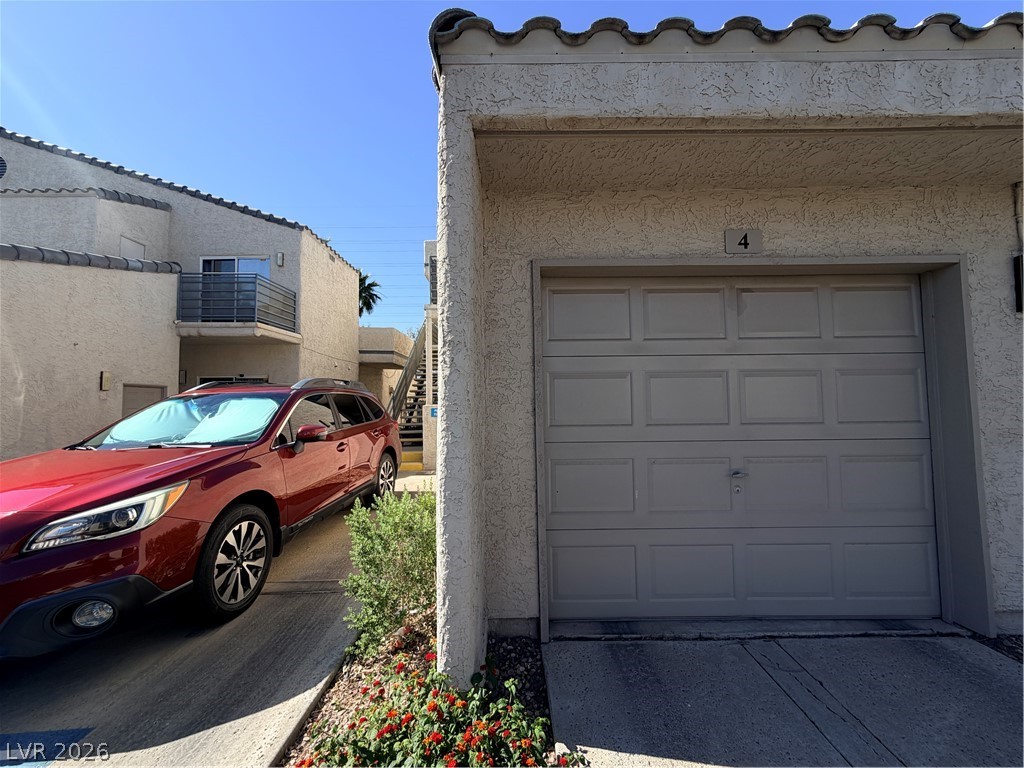 6250 West Flamingo Road, Unit 4 Las Vegas, NV 89103 - Photo 39 of 45 This residential property showcases a well-maintained exterior and an attached garage.