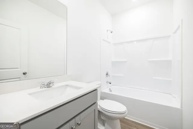 a bathroom with a sink a toilet and a bathtub