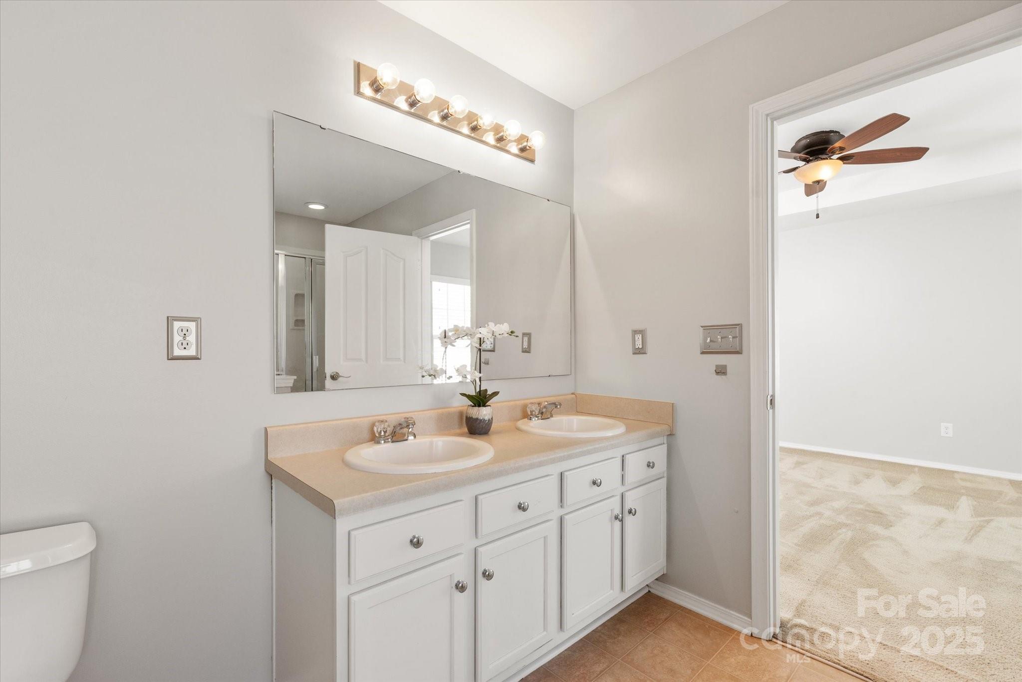 158 Council House Road Fort Mill, SC 29708 - Photo 21 of 41 a bathroom with a double vanity sink and mirror with toilet