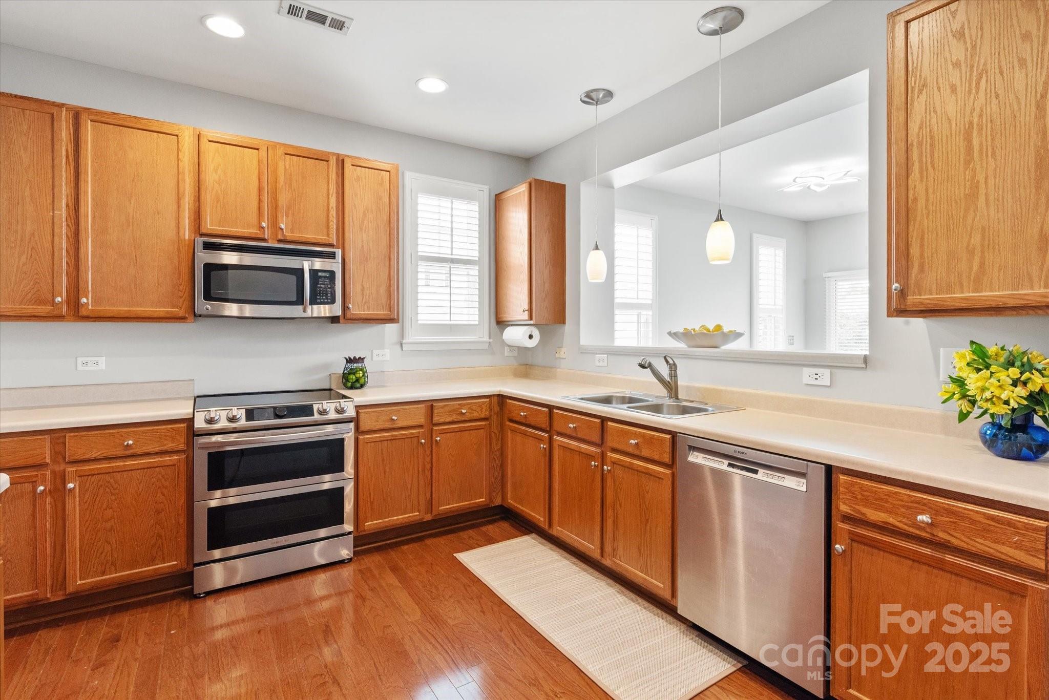 158 Council House Road Fort Mill, SC 29708 - Photo 5 of 41 a kitchen with stainless steel appliances granite countertop wooden cabinets a sink and a stove