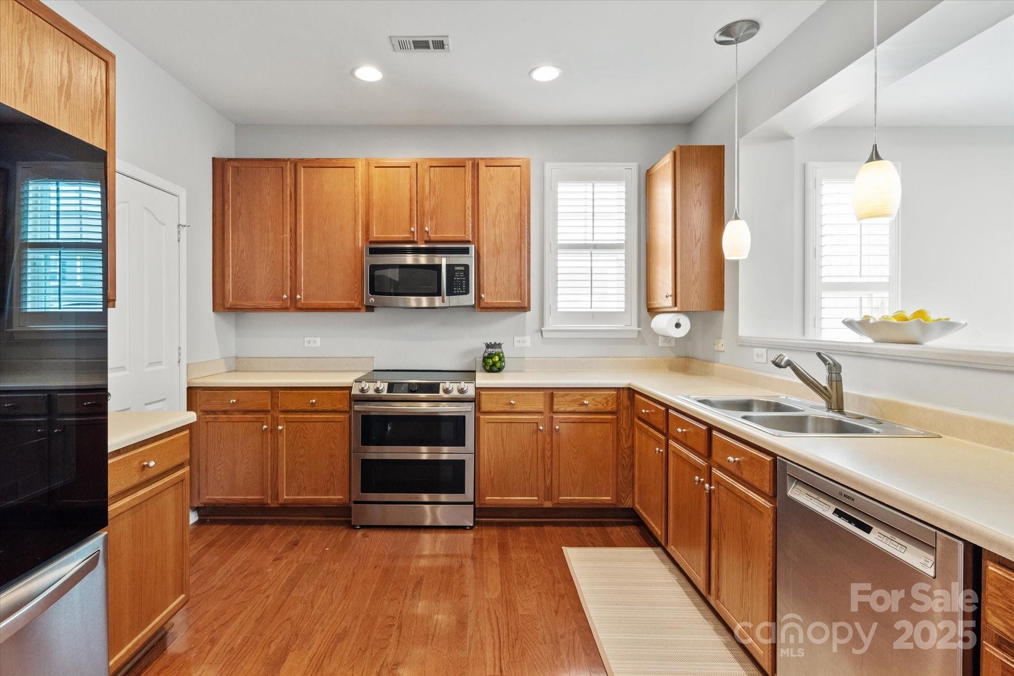 158 Council House Road Fort Mill, SC 29708 - Photo 6 of 41 a kitchen with stainless steel appliances granite countertop wooden cabinets a stove a sink and a microwave