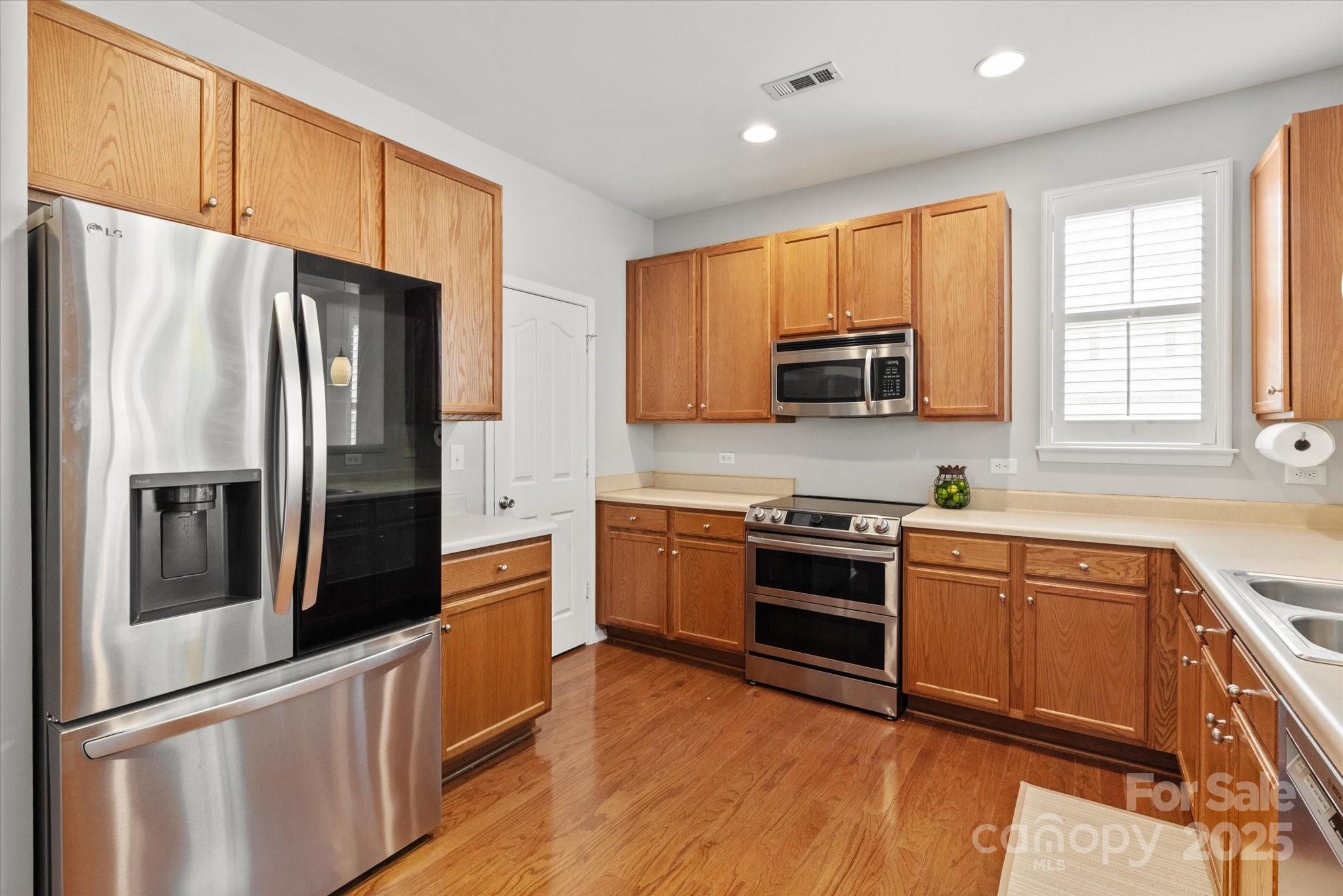 158 Council House Road Fort Mill, SC 29708 - Photo 7 of 41 a kitchen with stainless steel appliances granite countertop a refrigerator a stove top oven a sink and dishwasher