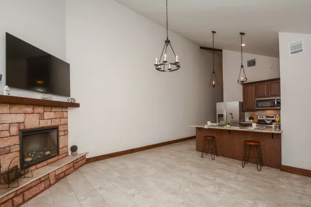 a view of kitchen with granite countertop microwave and stove