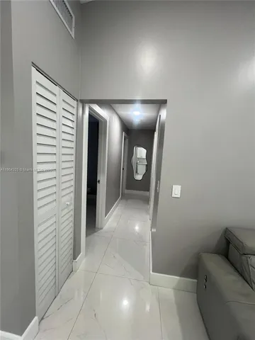 a kitchen with a refrigerator a microwave and sink