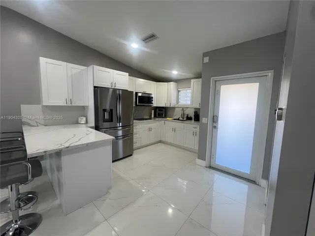 a large white room with furniture