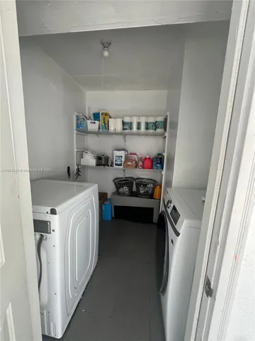 a bathroom with a granite countertop toilet a sink a shower and a mirror