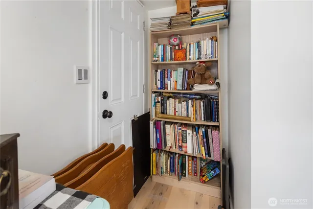 a living room with a book shelf and a book shelf