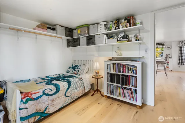 a bedroom with a bed and a book shelf