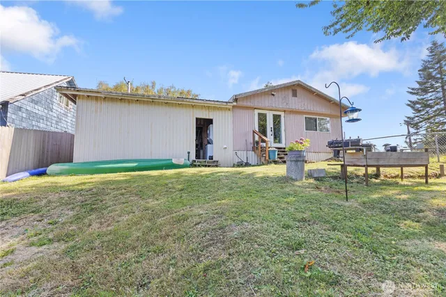 a backyard of a house with table and chairs