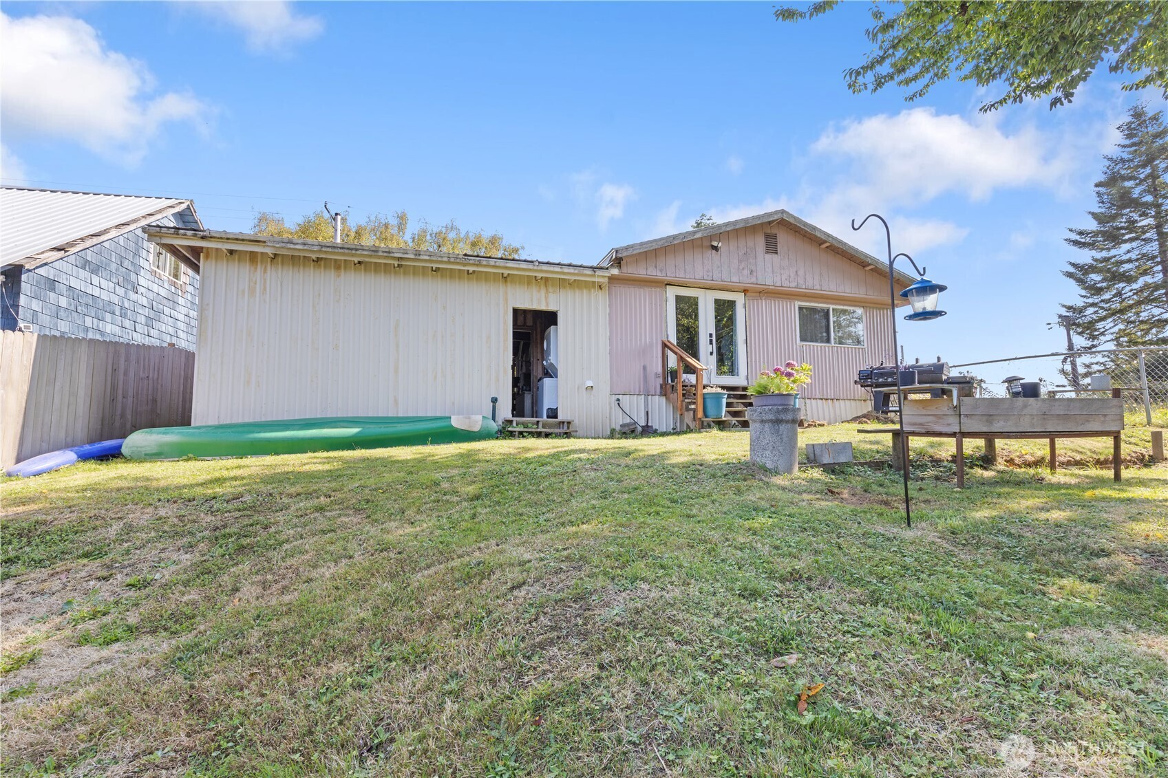 21 2nd Street Bay Center, WA 98586 - Photo 18 of 21 a backyard of a house with table and chairs