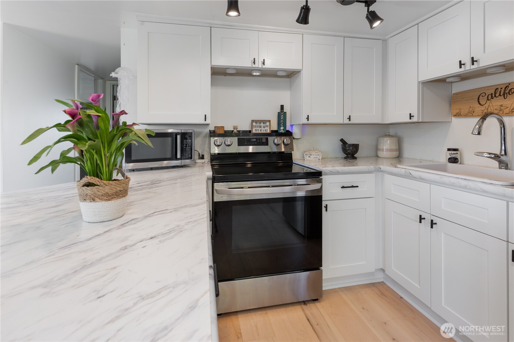 21 2nd Street Bay Center, WA 98586 - Photo 6 of 21 a kitchen with appliances cabinets and a potted plant