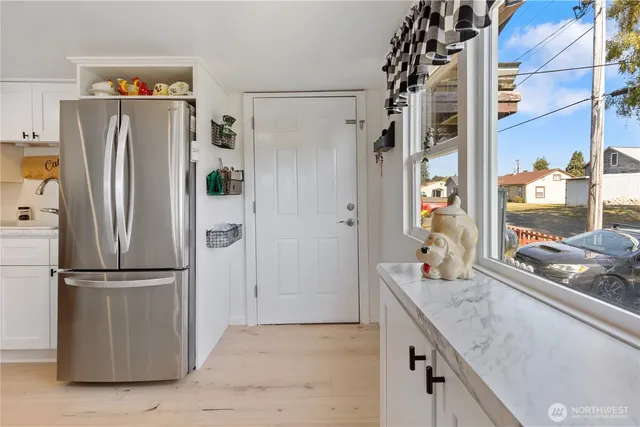 a kitchen with stainless steel appliances granite countertop a refrigerator and a counter