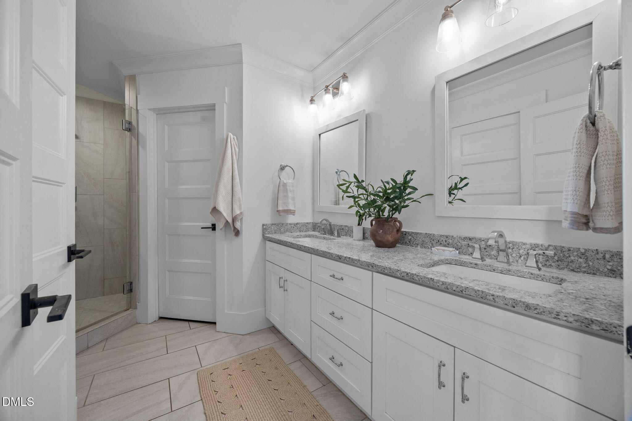 603 Frank Street Raleigh, NC 27604 - Photo 11 of 29 a bathroom with a granite countertop sink a mirror and a shower