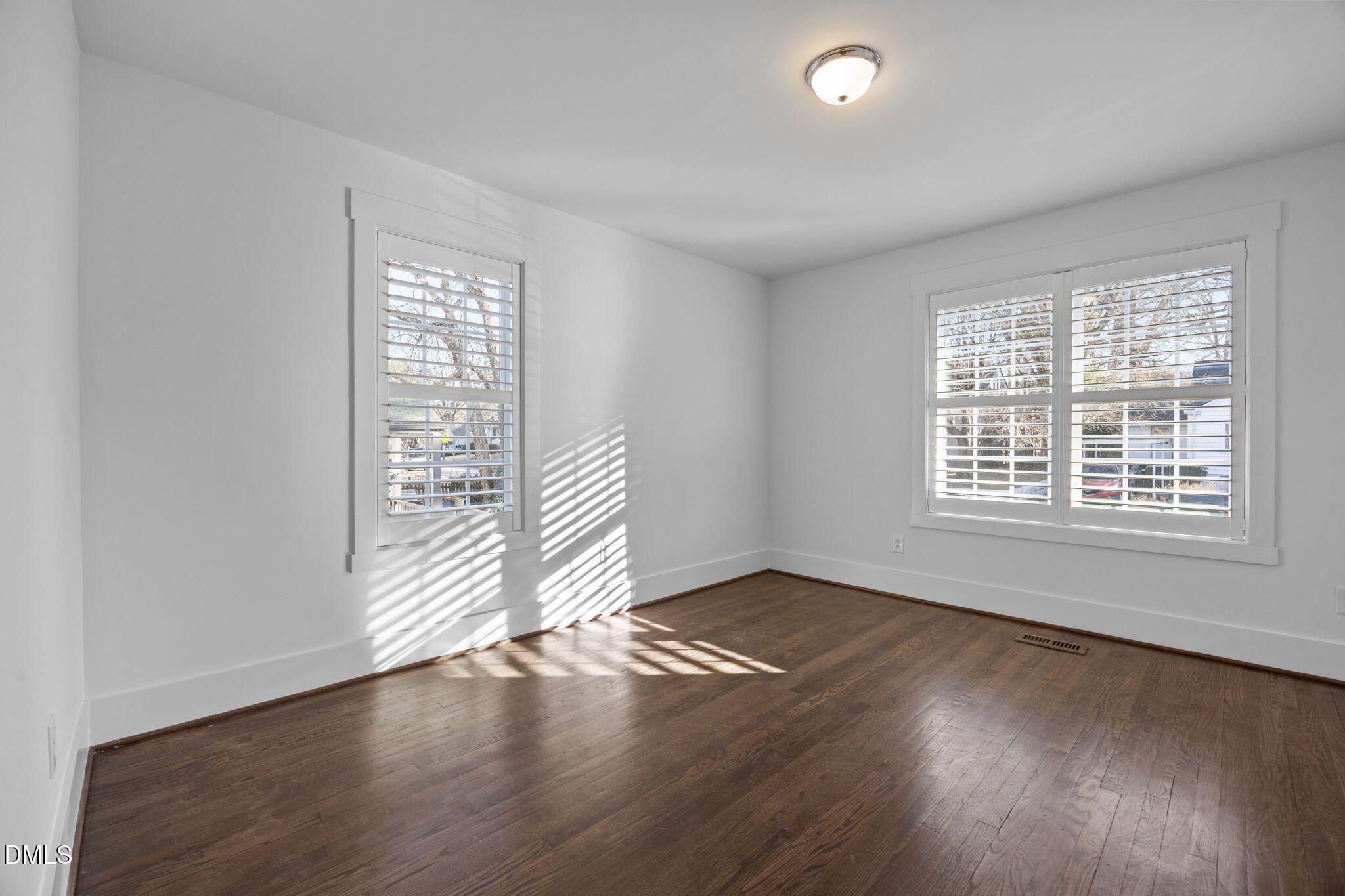 603 Frank Street Raleigh, NC 27604 - Photo 15 of 29 an empty room with wooden floor and windows