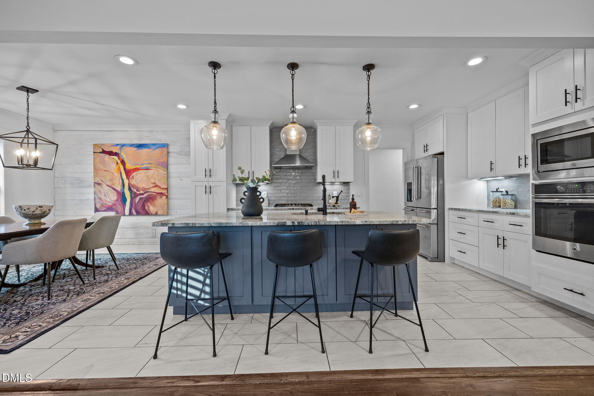 603 Frank Street Raleigh, NC 27604 - Photo 5 of 29 a kitchen with stainless steel appliances kitchen island granite countertop a stove a sink a dining table and chairs